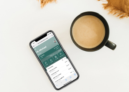 Conceptual photo of mobile phone next to cup of coffee