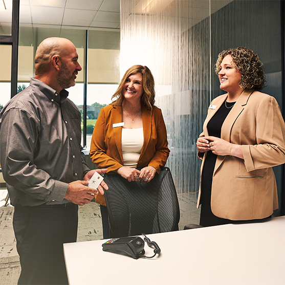 Customers meeting with OakStar Bank team members to discuss personal banking services.