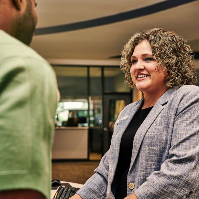 An OakStar Bank team member discussing personal savings account options with a customer.