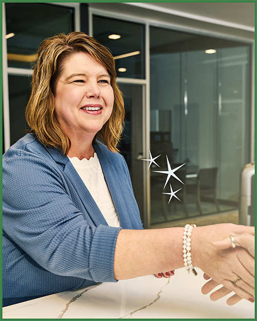 An OakStar Bank team member welcoming customers with community-focused banking.