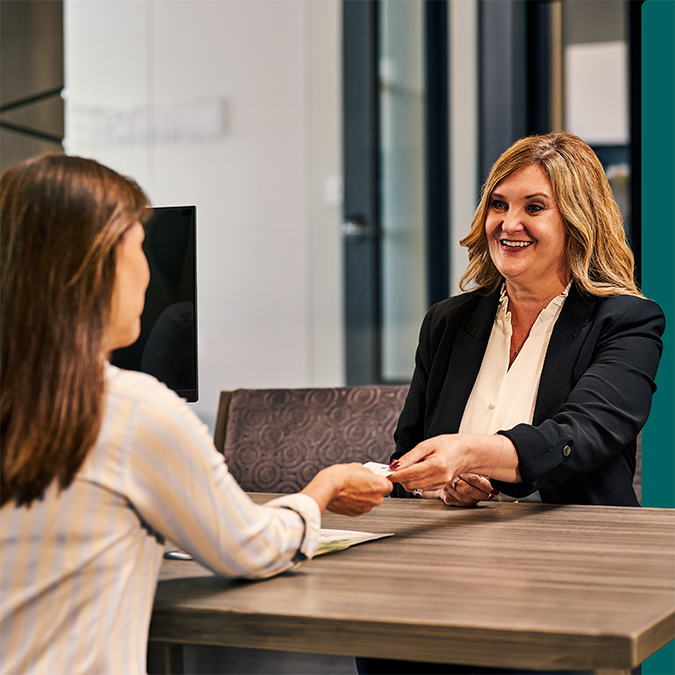 An OakStar Bank team member discussing checking account options with a customer.