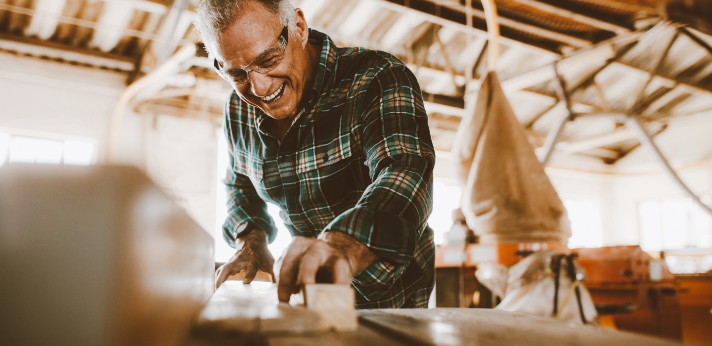 Man working in the shop sawing wood.