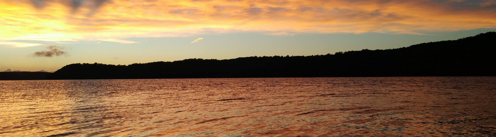 View of the lake of the ozarks on the water at golden hour