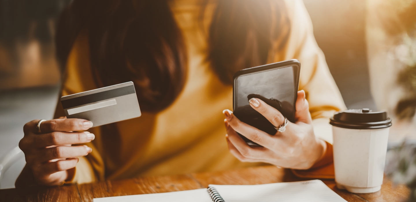 Woman holding phone and credit card