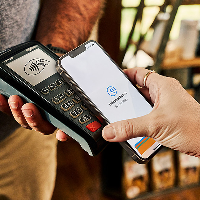 A customer making a mobile wallet payment with a smartphone.