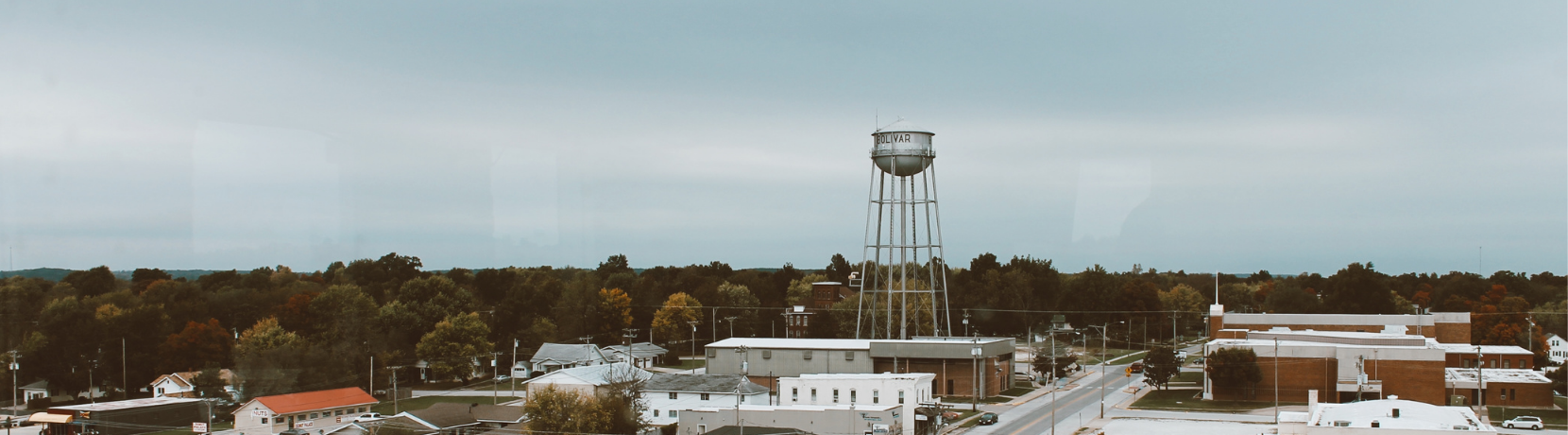 An aerial image of a town with a water tower.