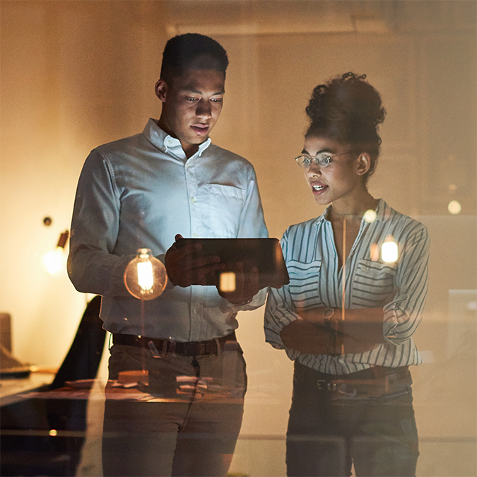 Business owners monitoring account activity with digital banking tools.