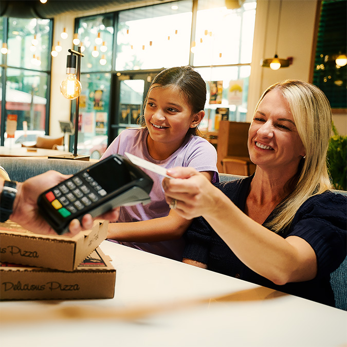 A customer building savings through everyday spending with OakStar Bank.