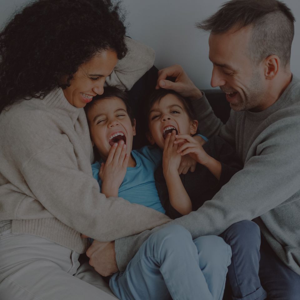 Parents tickling their children