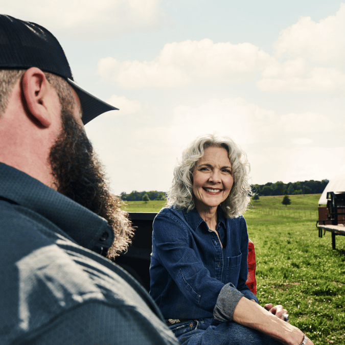 An OakStar Bank lender providing ongoing support to a farmer.
